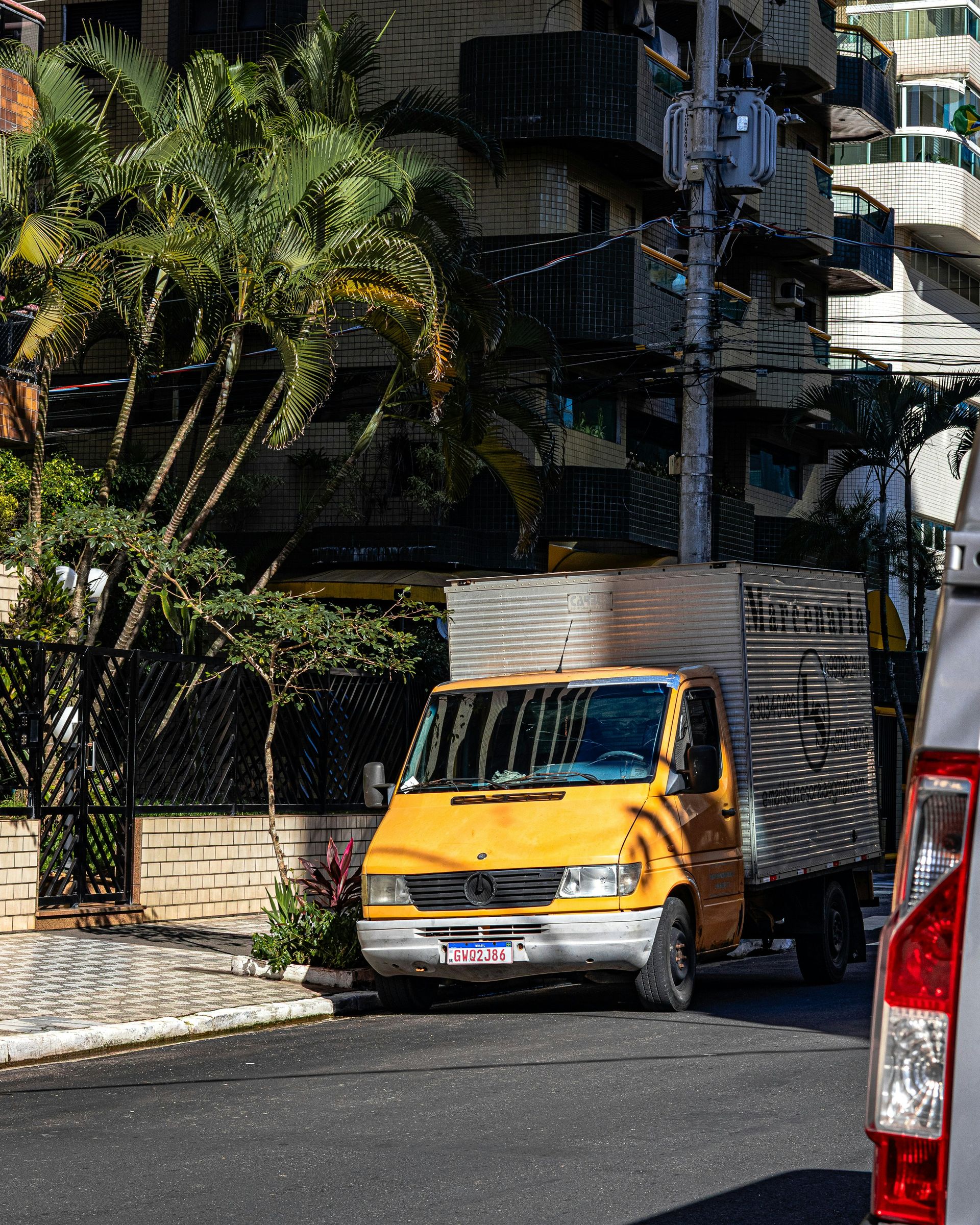 A yellow delivery truck parked on a city street.